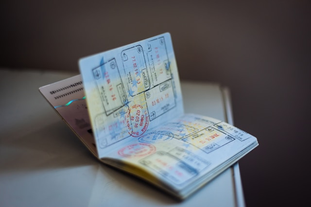 A passport with visa stamps to represent us submitting a visa application.